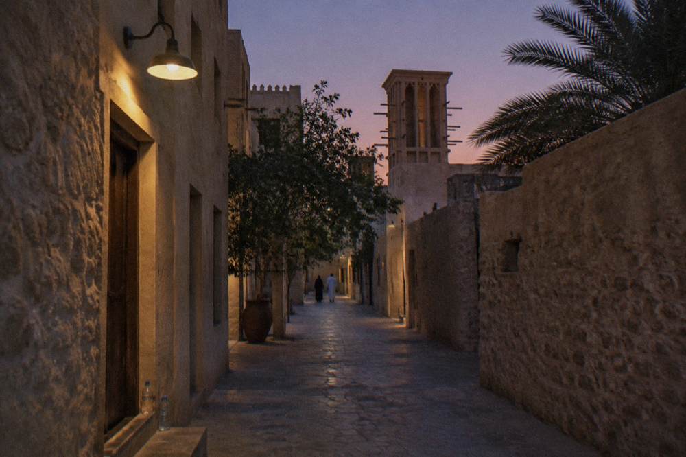 A heritage-style district street with wind tower architecture in Old Dubai
