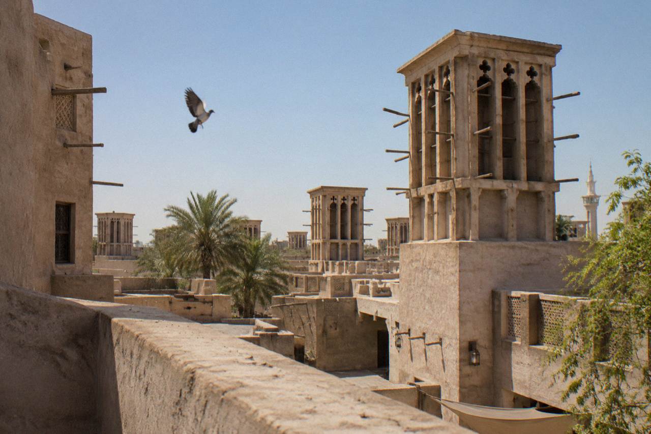 Traditional wind tower buildings in the Al Fahidi Historical Neighbourhood of old Dubai under a clear sky