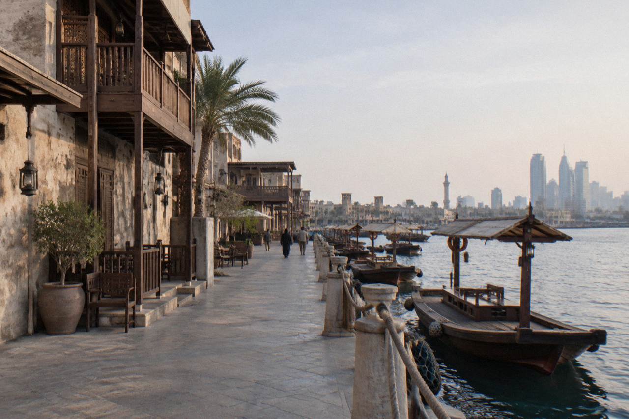 Heritage style buildings with wooden balconies along a waterfront promenade in Al Seef Dubai