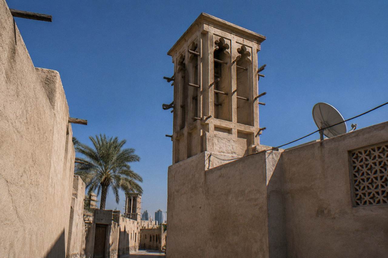 Traditional wind tower buildings in the Al Fahidi Historical Neighbourhood of old Dubai under a clear sky