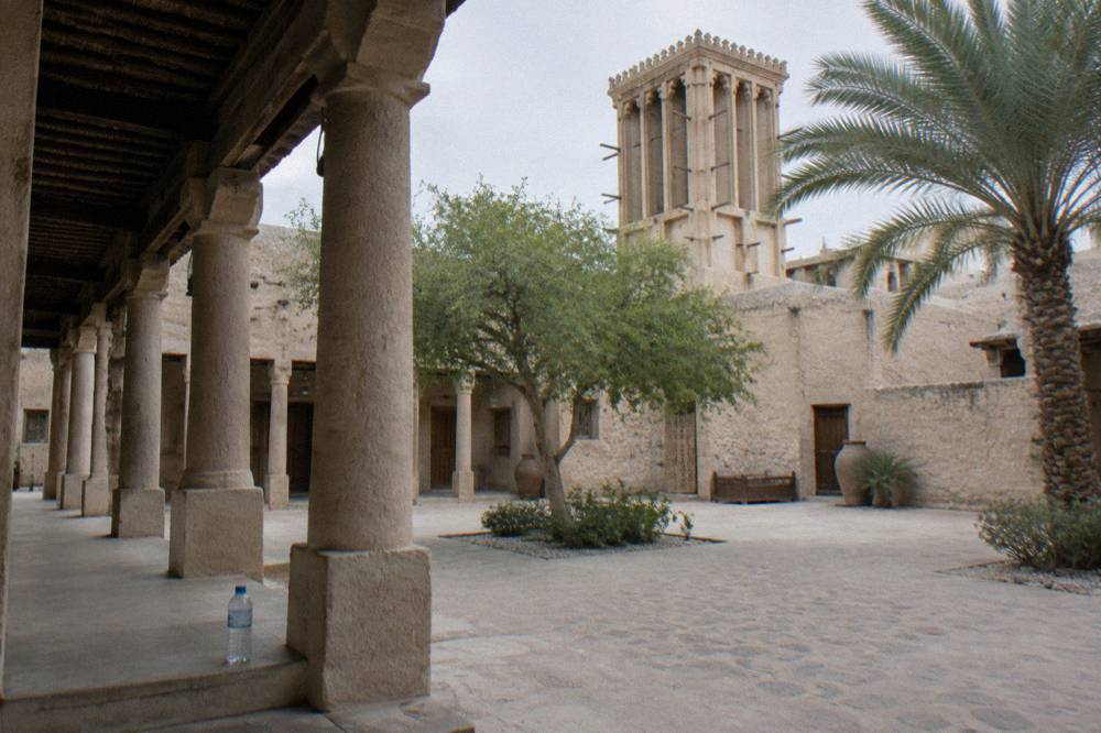 A heritage-style courtyard area in old Dubai with shaded walkways