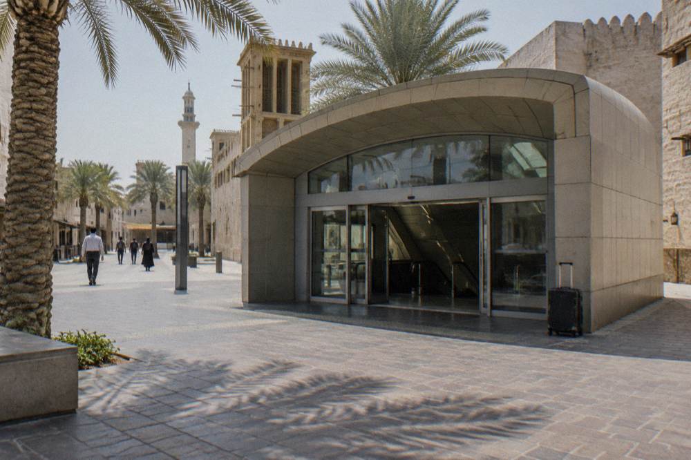 A Dubai transport interchange with a station entrance in daylight