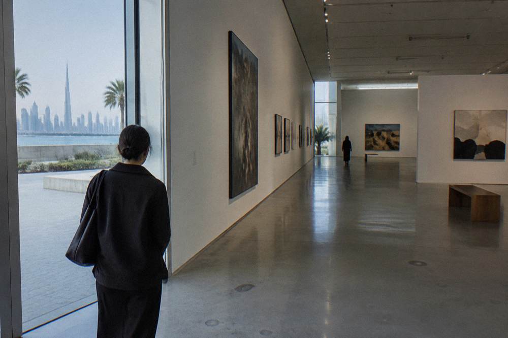 Modern gallery interior with polished floor and artworks on white walls