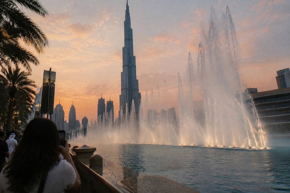The Dubai Fountain jets in Burj Lake with the Burj Khalifa tower rising behind them