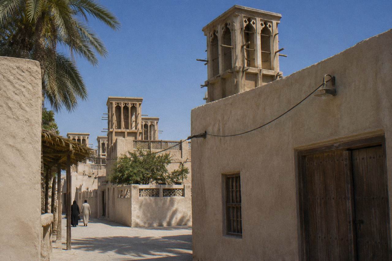 Traditional wind tower buildings in the Al Fahidi Historical Neighbourhood of old Dubai under a clear sky