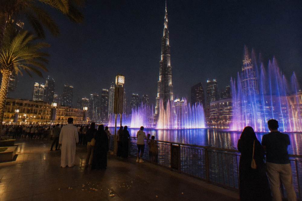 The Dubai Fountain performing illuminated water jets at dusk over Burj Lake