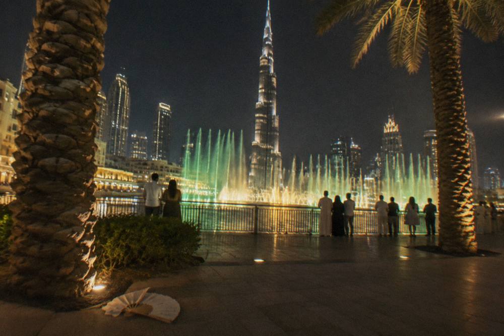 The Dubai Fountain water jets rising over Burj Lake in the evening