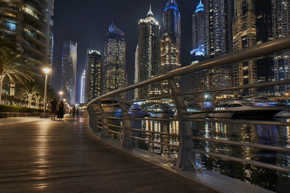 Dubai Marina waterfront promenade lit up after dark