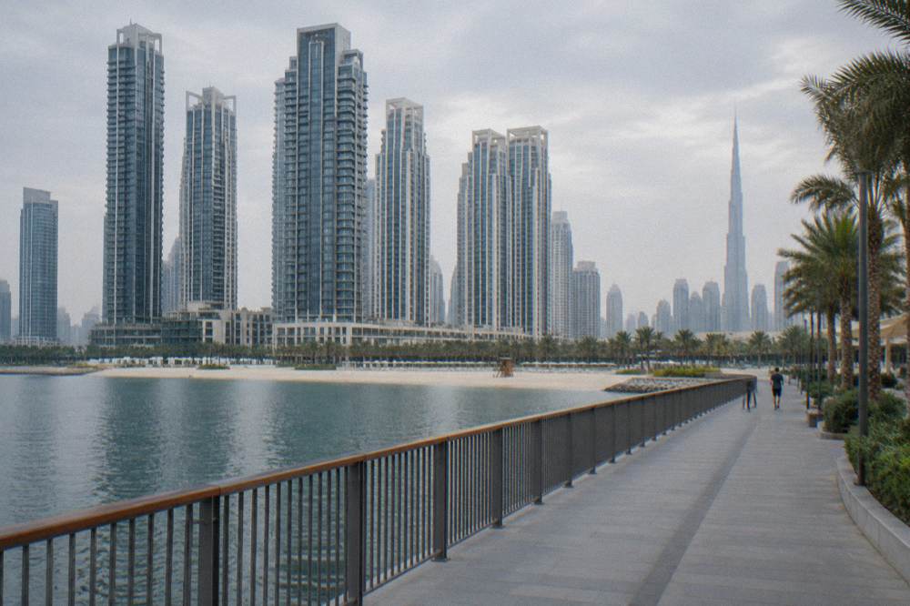 Modern high rise towers of Dubai seen from a public waterfront path