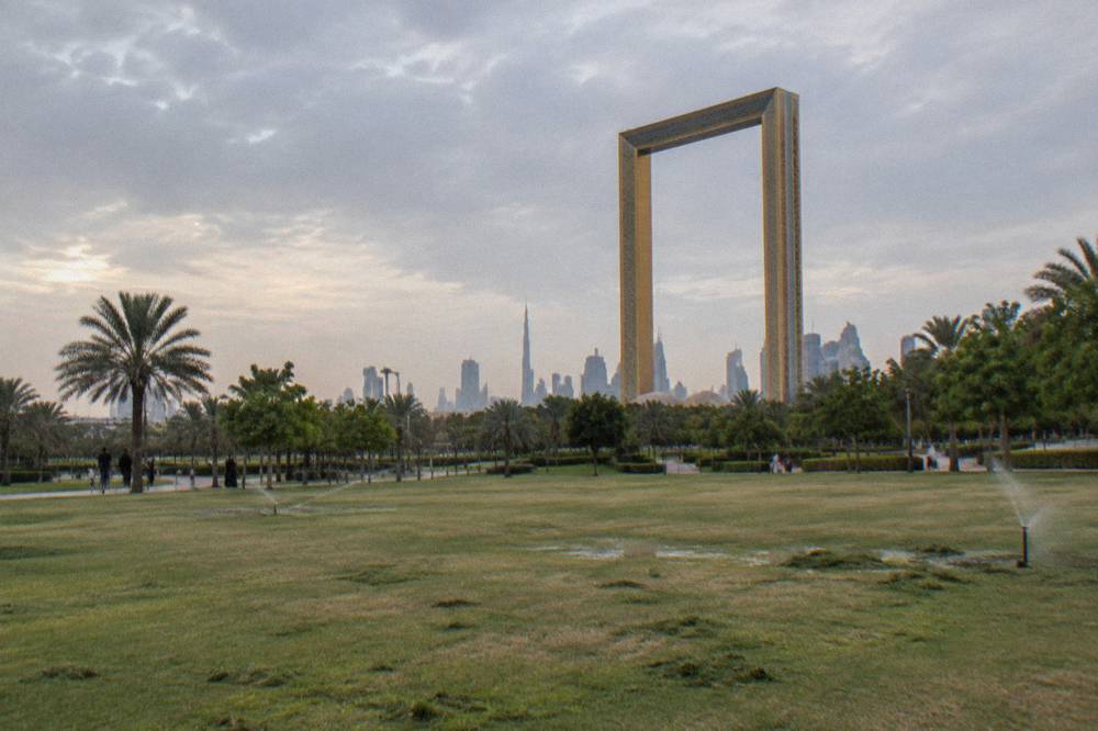 A tall rectangular picture-frame structure standing over a park lawn