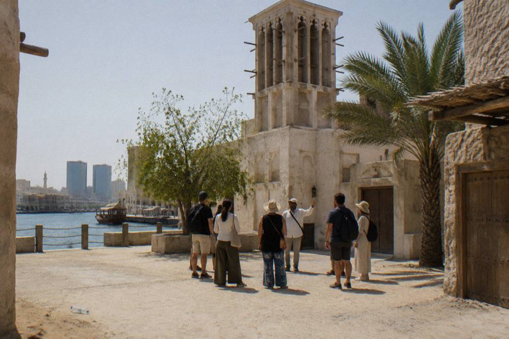 A guide leading a walking tour group in Old Dubai