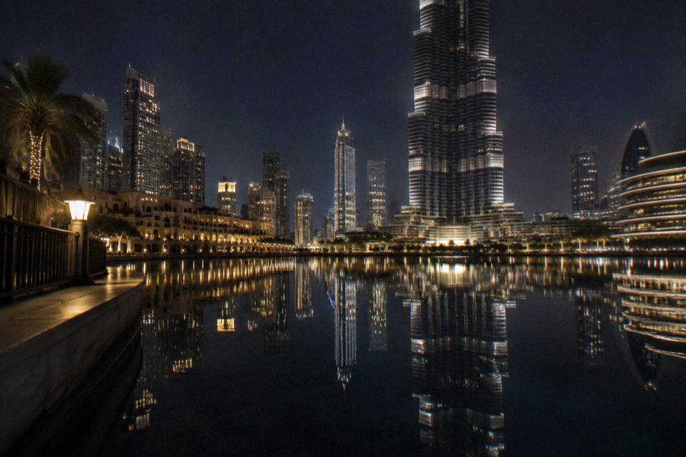 Calm lake at night with city reflections and no fountain jets