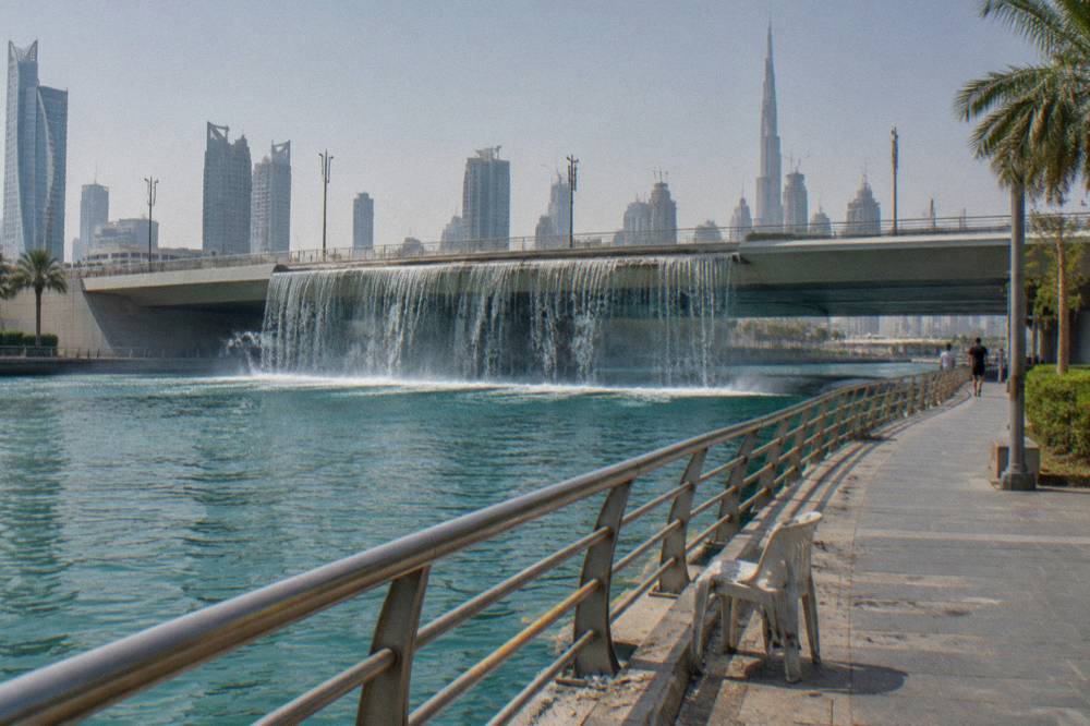 The Dubai Water Canal waterfall bridge with walkways alongside
