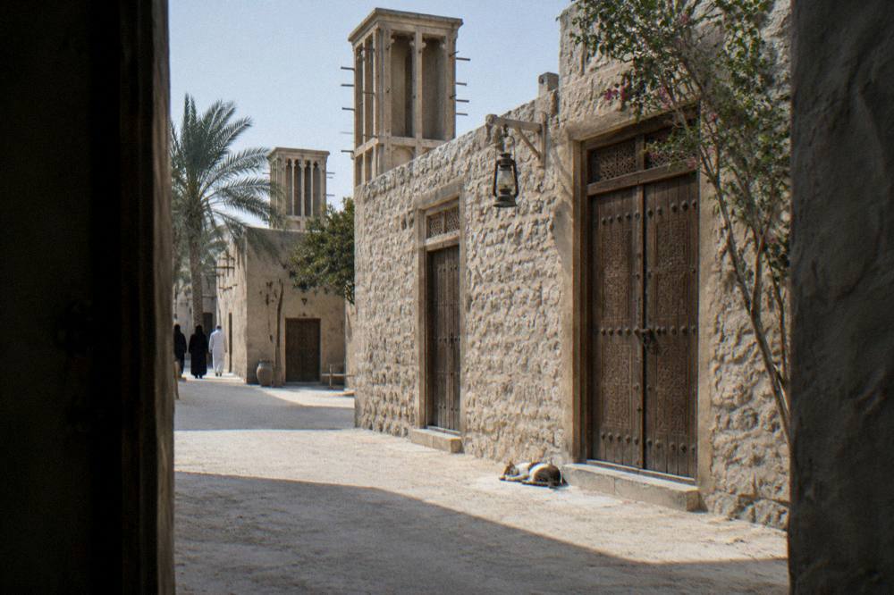 Narrow lane in the Al Fahidi Historical Neighbourhood with carved wooden doors
