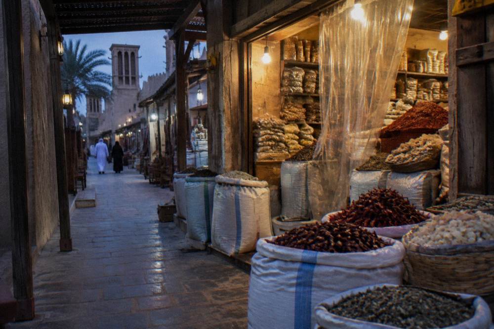 Shopfronts in a covered old Dubai souk lane