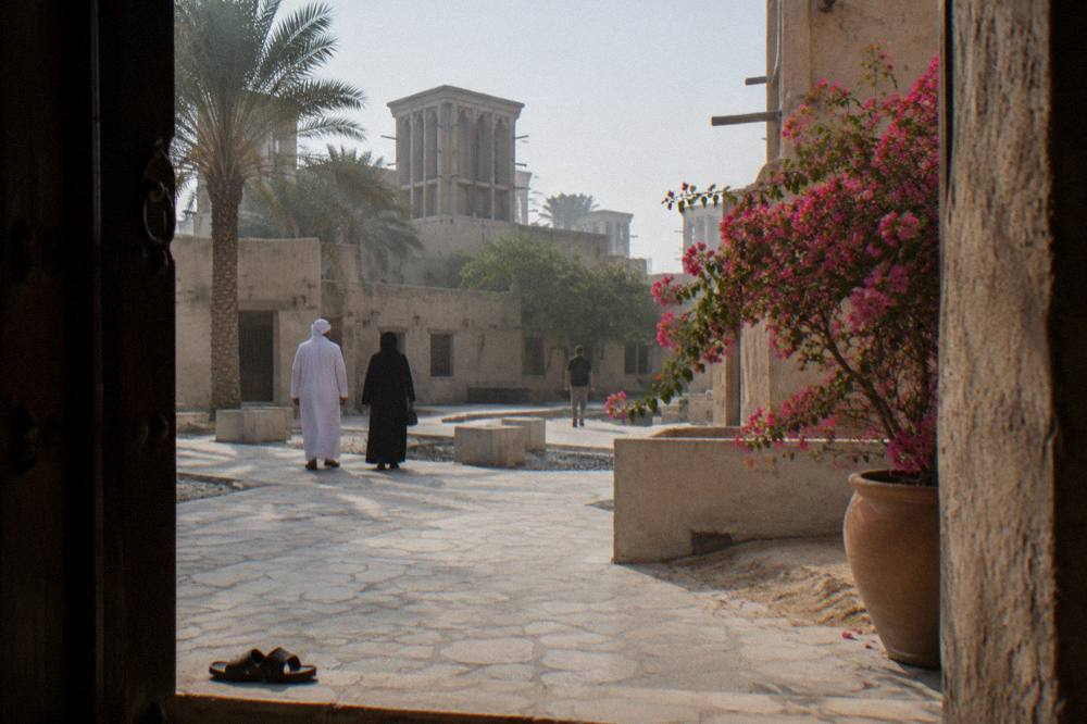 Group of walkers pausing in a heritage courtyard in Al Fahidi