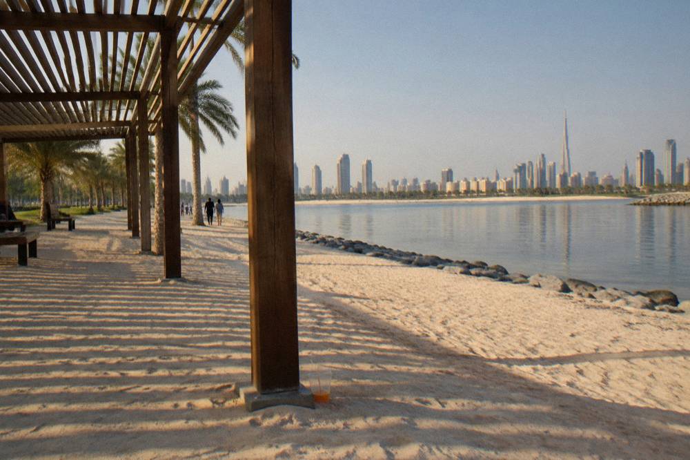 Beach park shoreline with shaded pergolas along the sand